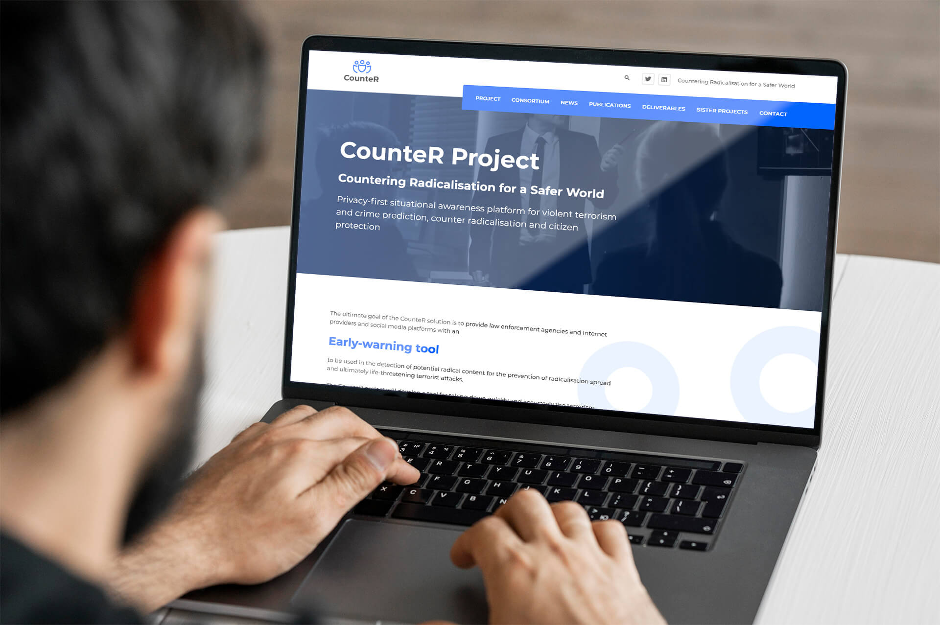 Man typing on a laptop with the Counter Project website open on the screen